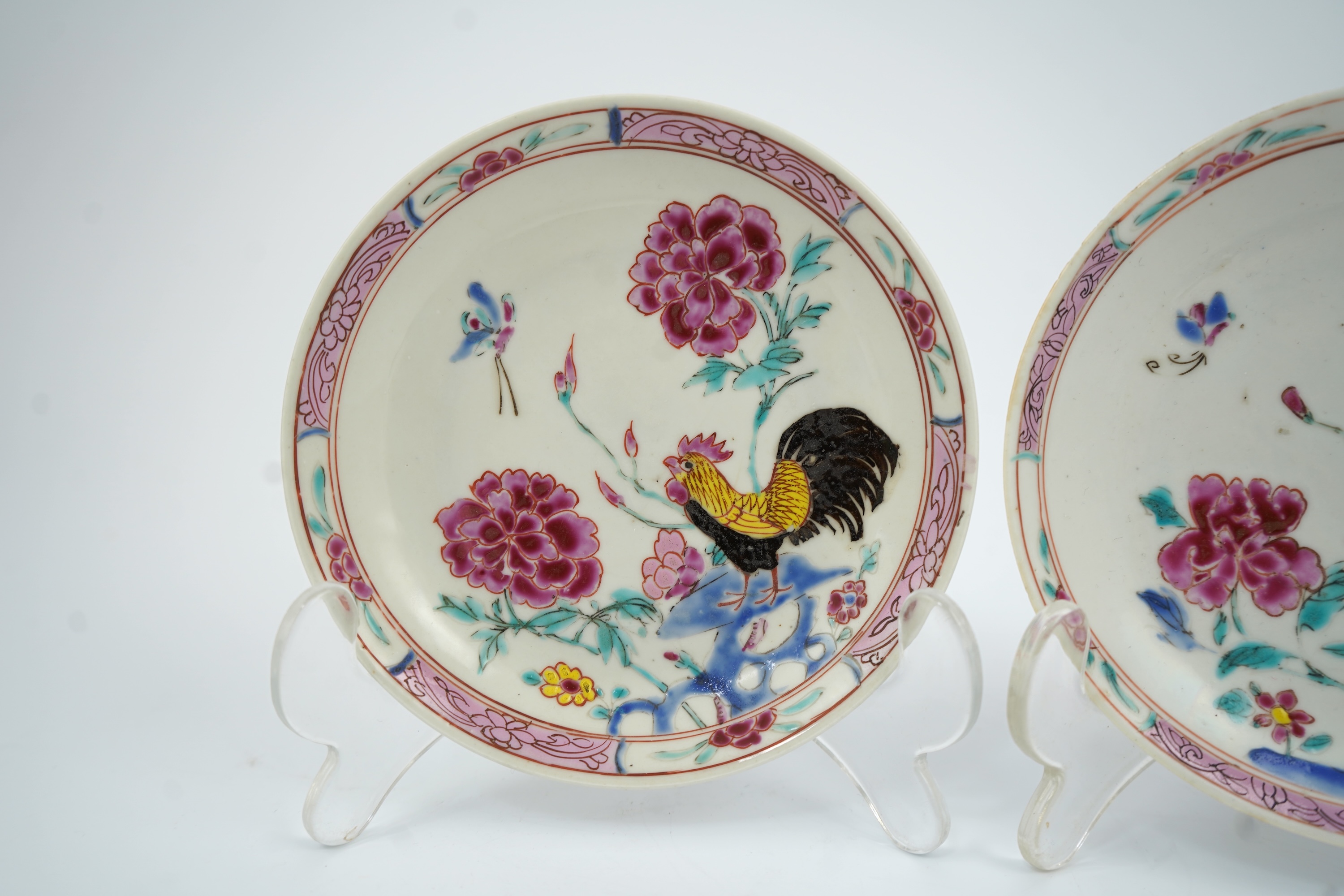 A near pair of Chinese famille rose ‘cockerel’ tea bowls and saucers, Yongzheng period